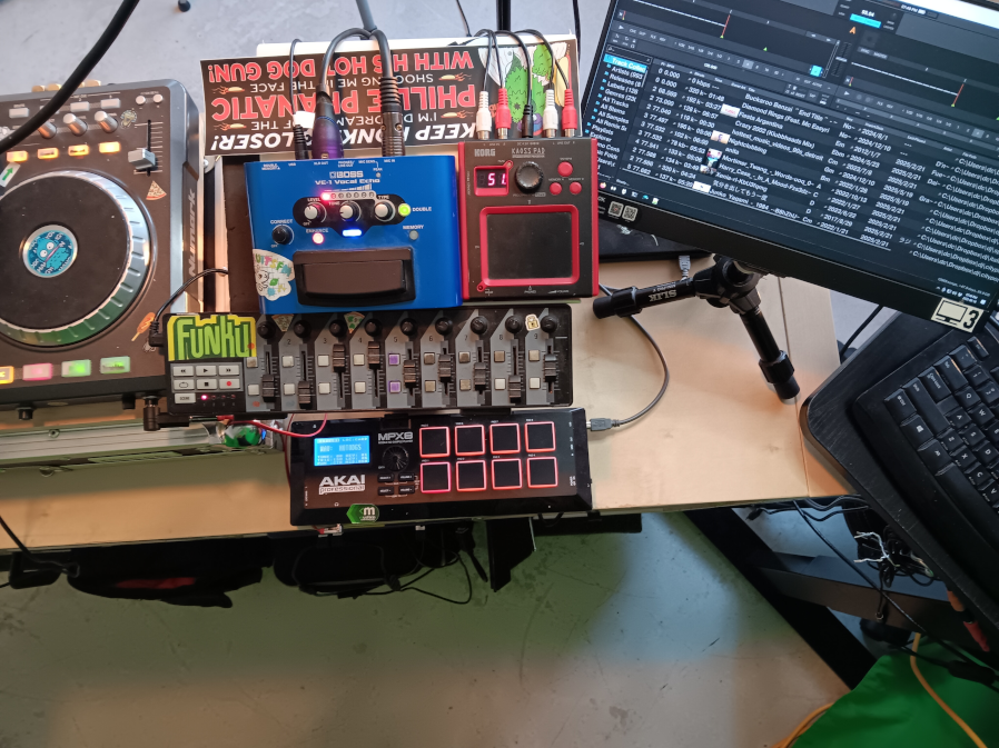 the mini KP, nanoKontrol, the sampler, vocal effect pedal, and monitor displaying the traktor browser