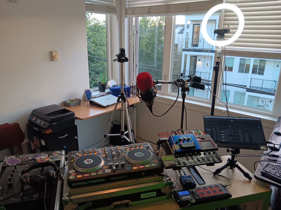 POV shot of standing at the DJ station with the 3 webcams, ring light, and microphone pointed towards you