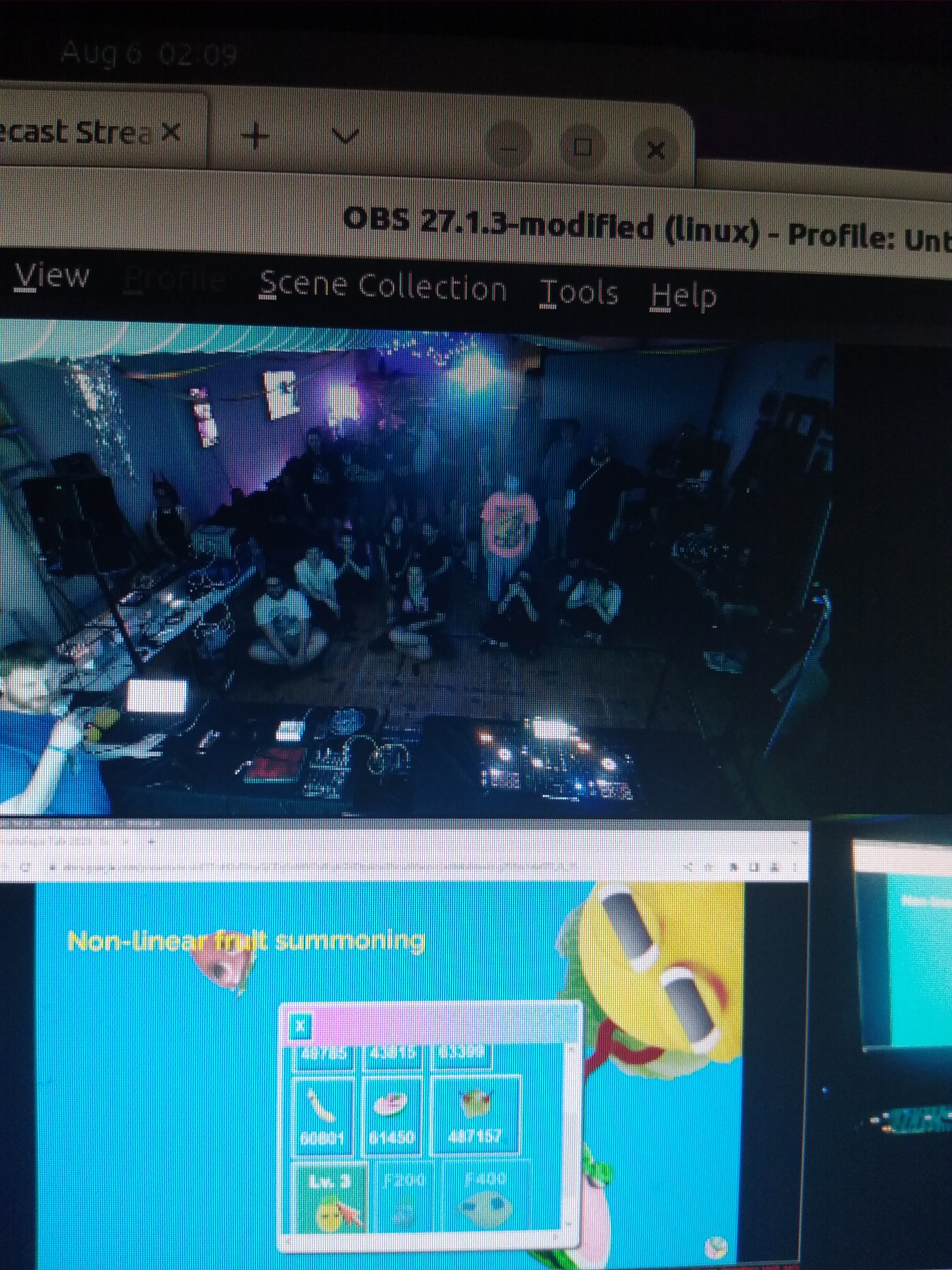 phone camera picture of a screen showing the crowd either standing or sitting as tony does a presentation for the 2nd nights crowd